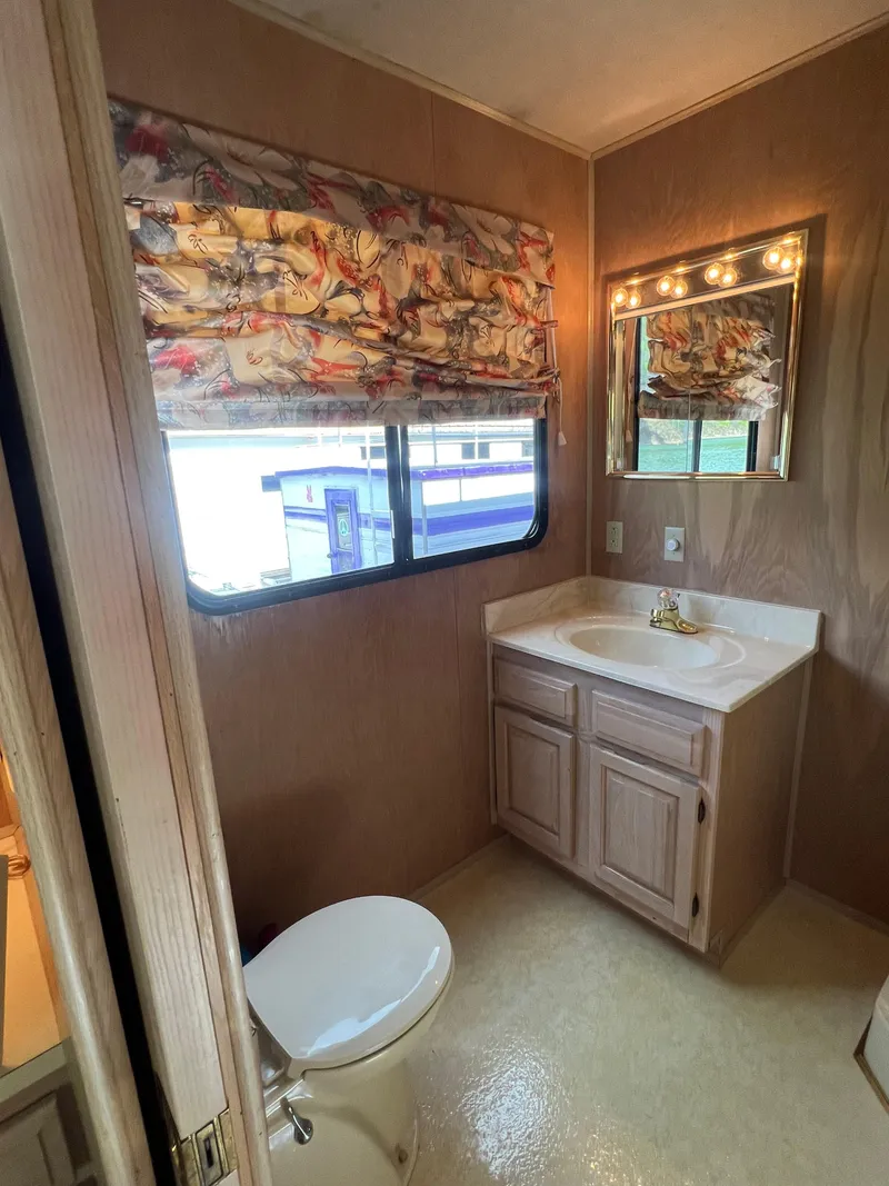Slide: The Image of Bathroom interior of a 1993 Sumerset houseboat with sink, mirror, and window. - 25
