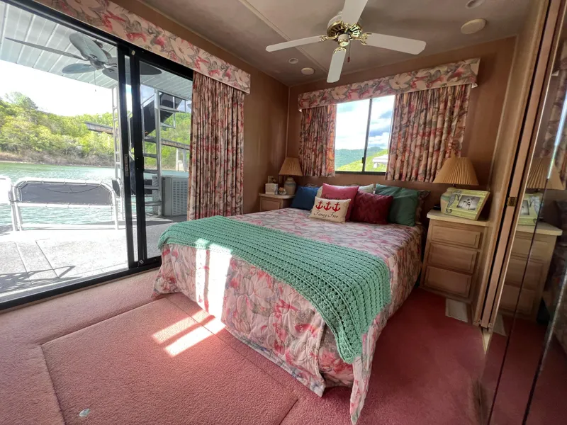 Slide: The Image of Cozy bedroom in 1993 Sumerset houseboat with floral decor and lake view. - 28