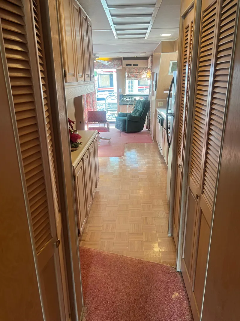 Slide: The Image of Interior of a 1993 Sumerset houseboat with wood paneling and cozy seating area. - 31