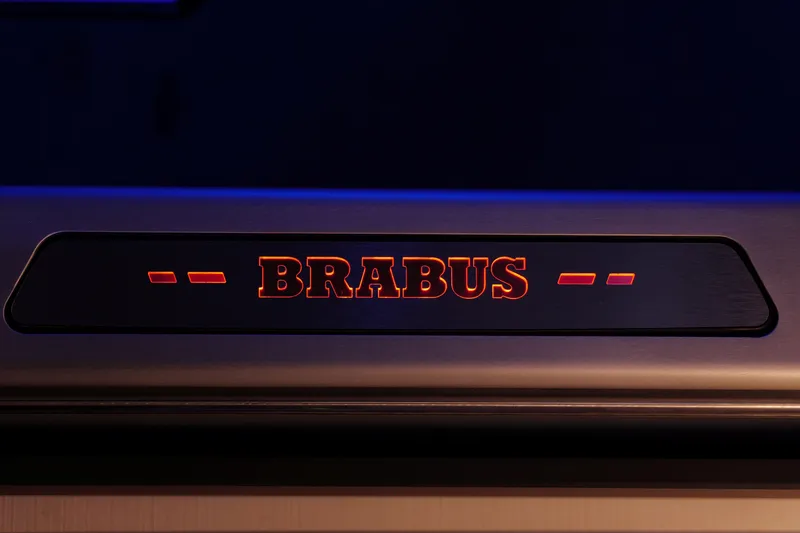 Slide: The Image of Illuminated BRABUS logo on 2026 BRABUS 1500 vehicle interior. - 21