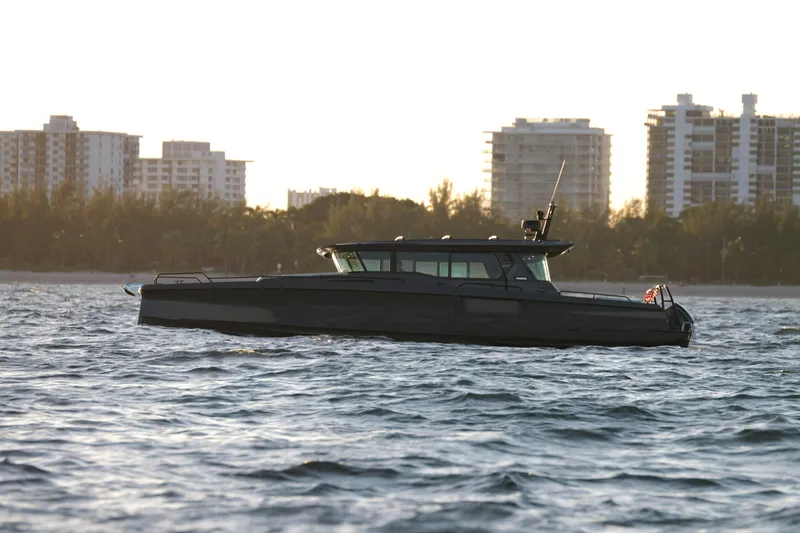 Slide: The Image of 2026 BRABUS 1500 yacht cruising on water with city skyline in background. - 4