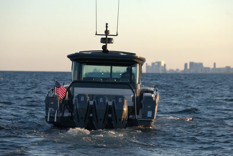 Slide: The Image of 2026 BRABUS 1500 boat cruising on open water with city skyline in background. - 13