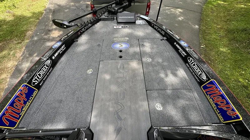 Slide: The Image of 2024 Vexus DVX20 boat deck with fishing gear and sponsor logos. - 12