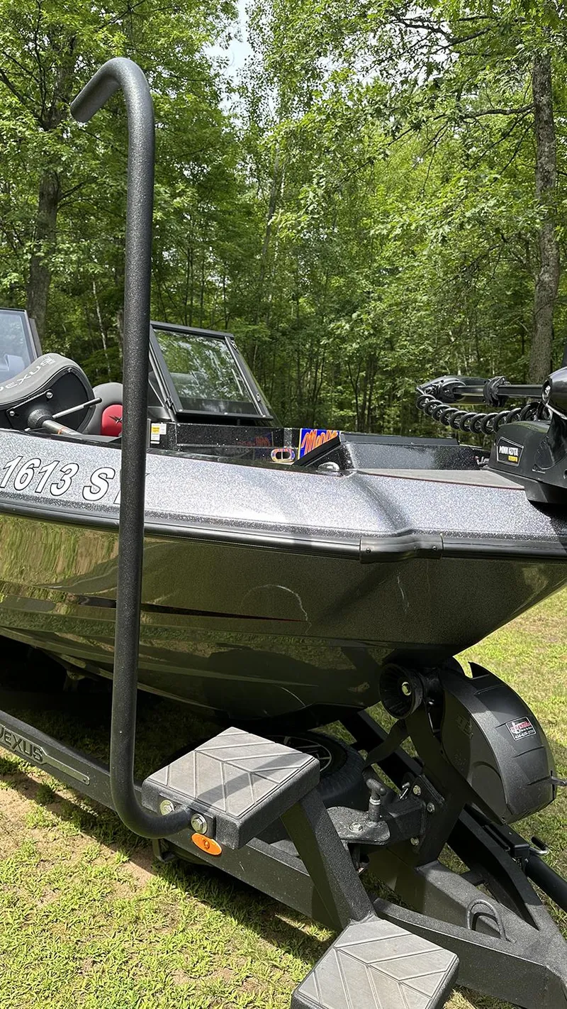 Slide: The Image of 2024 Vexus DVX20 boat on trailer, surrounded by lush green trees. - 13