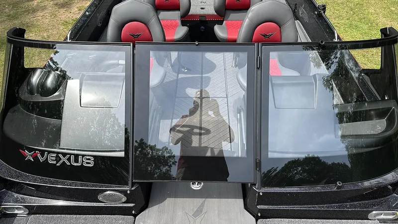 Slide: The Image of 2024 Vexus DVX20 boat interior with red and black seating, sleek windshield design. - 14