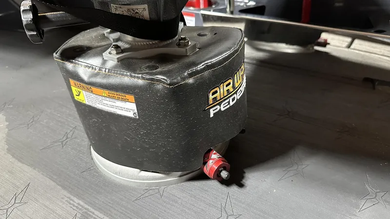 Slide: The Image of 2024 Vexus DVX20 AirWave pedestal base with warning label and star-patterned flooring. - 17