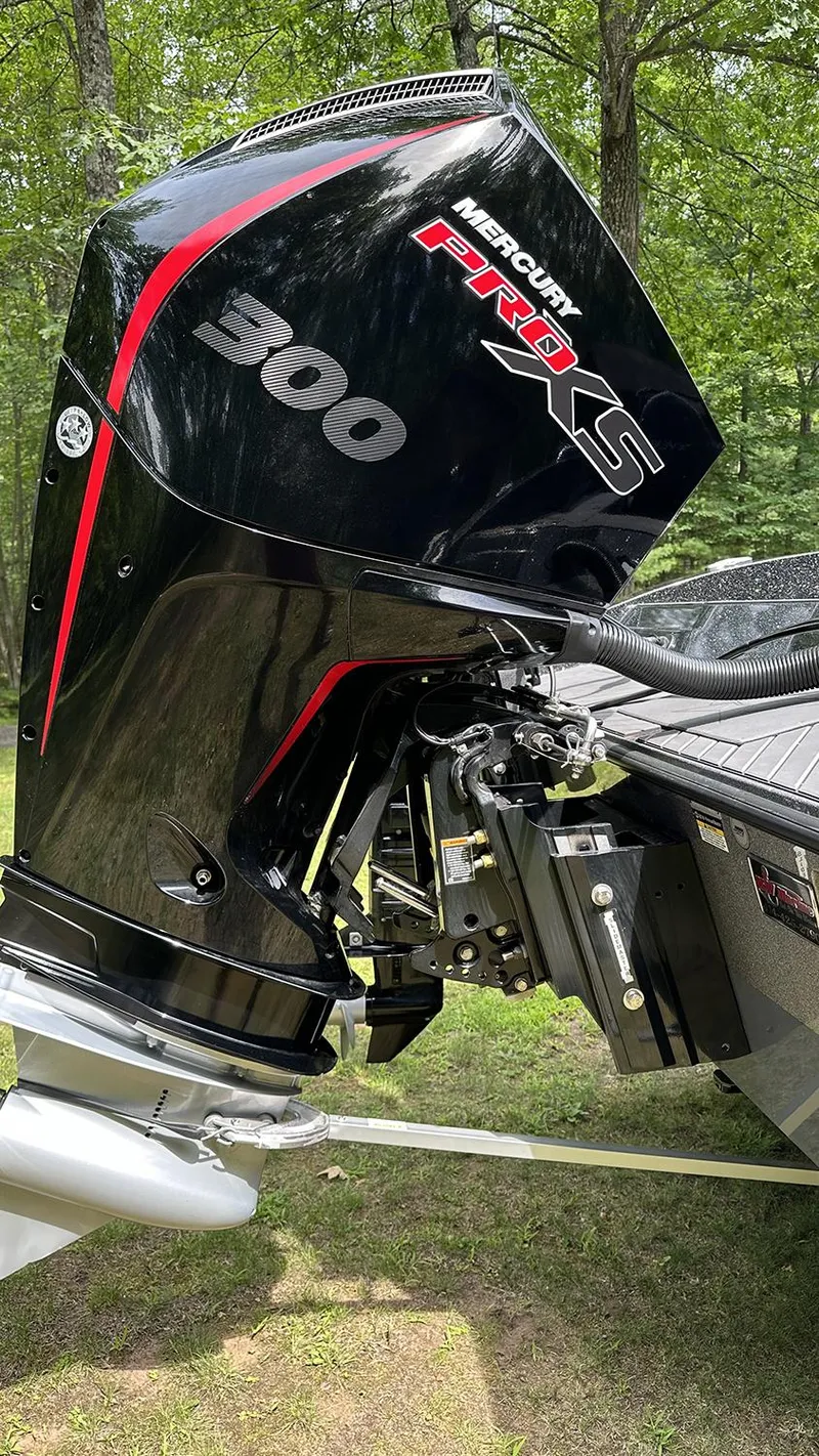 Slide: The Image of 2024 Vexus DVX20 with Mercury Pro XS 300 outboard motor in a wooded setting. - 4