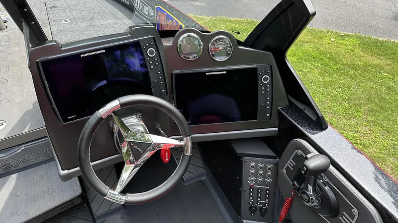 Slide: The Image of 2024 Vexus DVX20 boat dashboard with steering wheel, dual Humminbird displays, and control panel. - 9