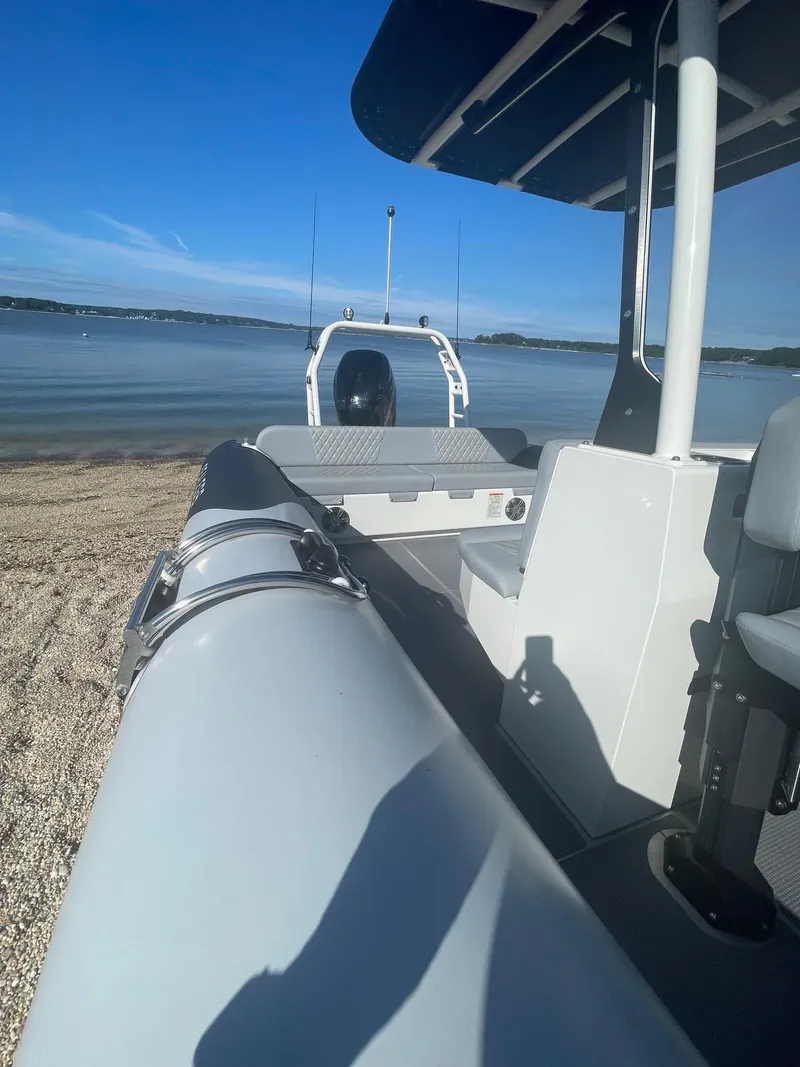 Slide: The Image of 2023 Sealegs 9M RIB on sandy beach with calm water and clear sky. - 8