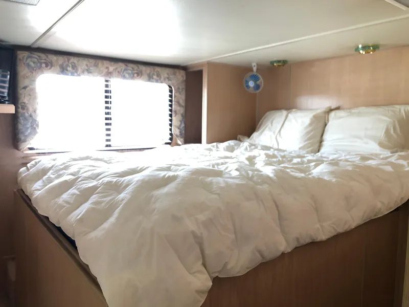 Slide: The Image of Cozy bedroom interior of 1997 Sumerset 75' X 16' houseboat with natural light. - 12