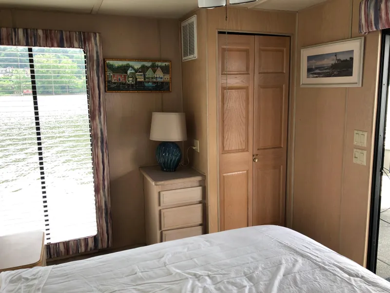 Slide: The Image of Interior of 1997 Sumerset houseboat bedroom with window, lamp, and artwork. - 16