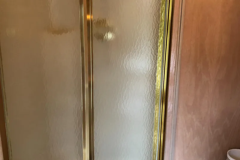 Slide: The Image of Frosted glass shower door with gold trim on a 1997 Sumerset houseboat. - 17
