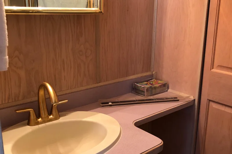 Slide: The Image of Wood-paneled bathroom with gold faucet in 1997 Sumerset 75' X 16' houseboat. - 19