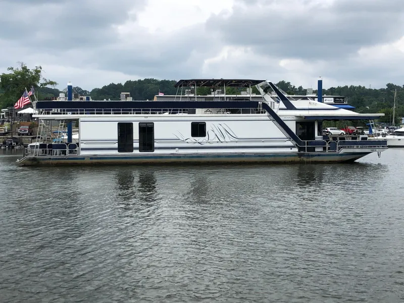 Slide: The Image of 1997 Sumerset 75' X 16' houseboat on calm water, overcast sky. - 2