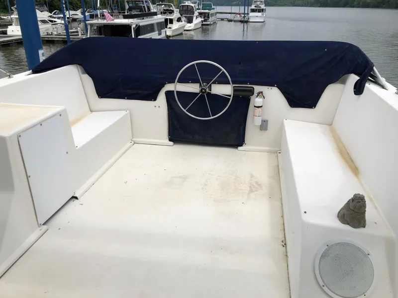 Slide: The Image of 1997 Sumerset 75' X 16' houseboat helm with covered steering wheel and seating. - 21