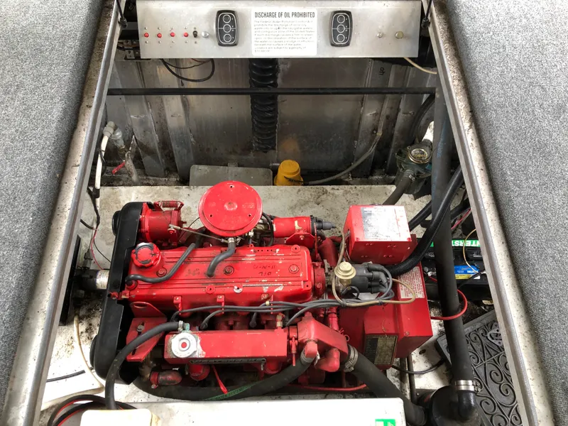 Slide: The Image of Engine compartment of a 1997 Sumerset 75' X 16' houseboat, featuring a red engine. - 25