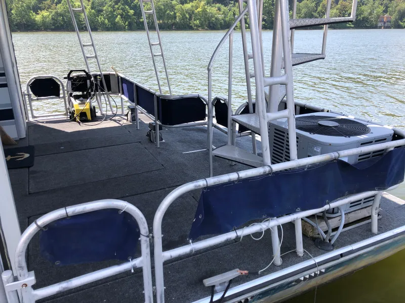 Slide: The Image of 1997 Sumerset 75' X 16' houseboat deck with spiral staircase and lake view. - 30