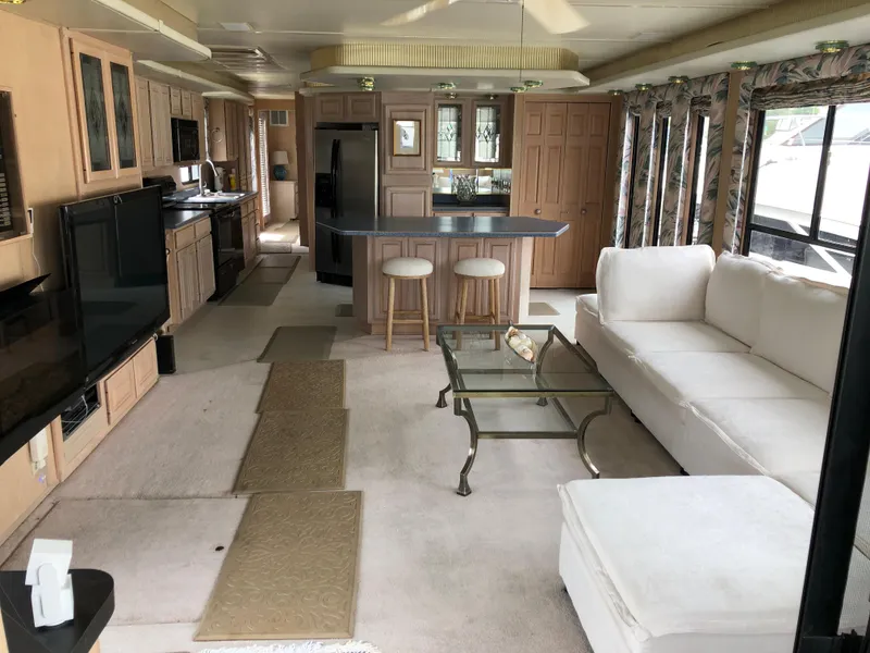 Slide: The Image of Luxurious interior of a 1997 Sumerset 75' X 16' houseboat with modern kitchen and cozy living area. - 4