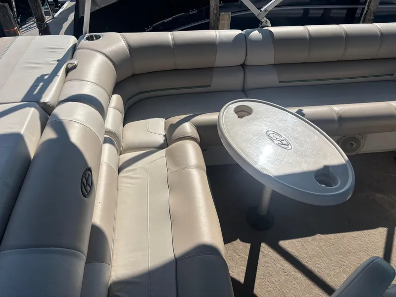 Slide: The Image of 2010 Harris FloteBote 200 Super Sunliner interior with beige seating and oval table. - 2