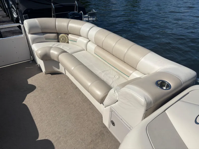 Slide: The Image of 2010 Harris FloteBote 200 Super Sunliner pontoon boat with beige seating by the water. - 4