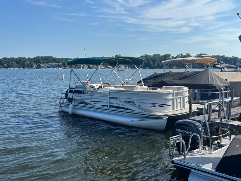 Slide: The Image of 2010 Harris FloteBote 200 Super Sunliner pontoon boat docked on a sunny lake. - 7
