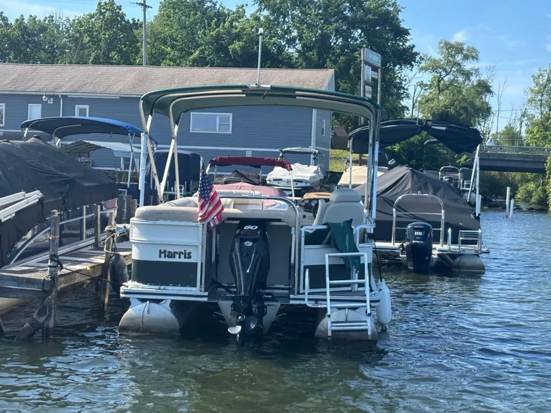 Slide: The Image of 2010 Harris FloteBote 200 Super Sunliner pontoon boat docked with American flag. - 9