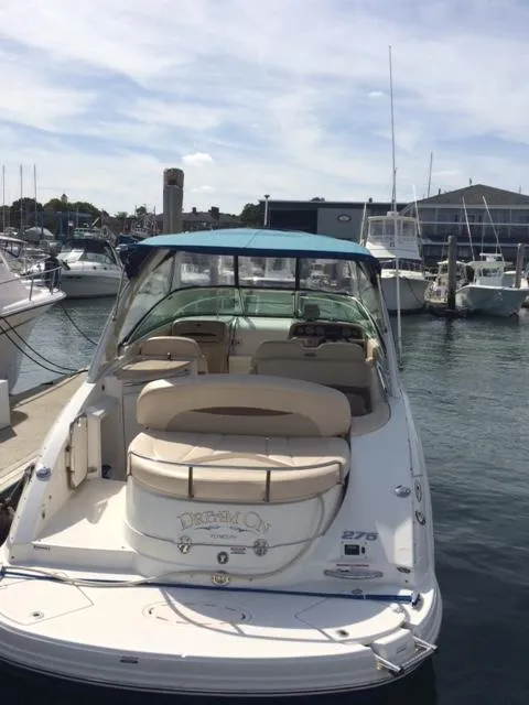 Slide: The Image of 2007 Chaparral 275 SSi boat docked at marina, featuring spacious seating and blue canopy. - 1