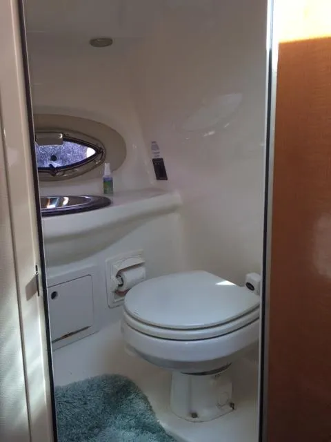 Slide: The Image of 2007 Chaparral 275 SSi boat bathroom with toilet, sink, and window. - 10