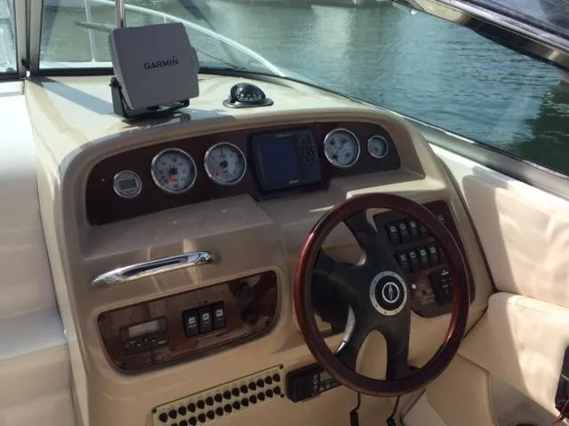 Slide: The Image of 2007 Chaparral 275 SSi boat dashboard with Garmin navigation system and steering wheel. - 2