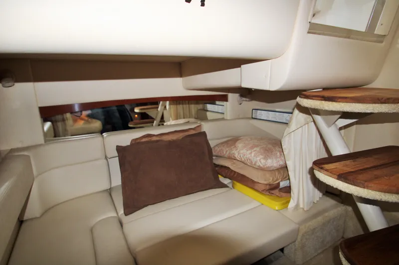 Slide: The Image of 2003 Sea Ray 320 Sundancer cabin interior with cushions and wooden steps. - 20