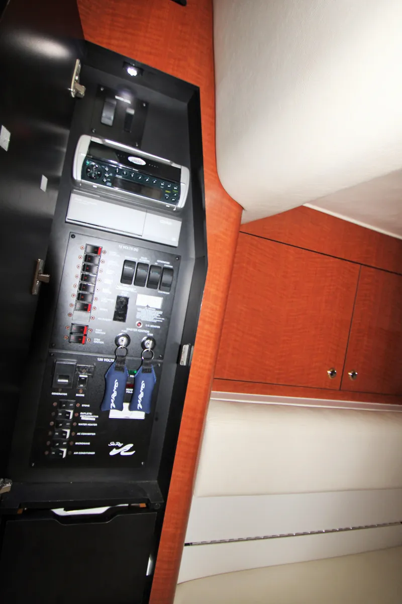 Slide: The Image of Electrical panel inside a 2003 Sea Ray 320 Sundancer yacht cabin. - 22