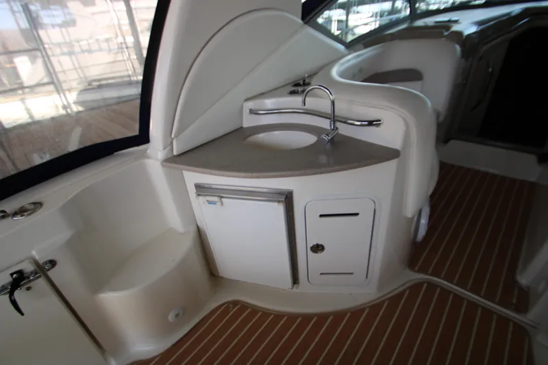 Slide: The Image of 2003 Sea Ray 320 Sundancer interior with sink and storage area. - 25
