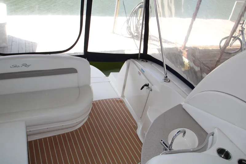Slide: The Image of Interior of 2003 Sea Ray 320 Sundancer with seating and kitchenette, dockside view. - 28