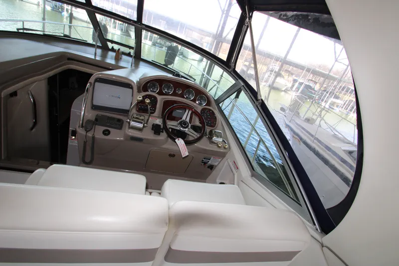 Slide: The Image of 2003 Sea Ray 320 Sundancer helm with steering wheel and navigation equipment. - 33