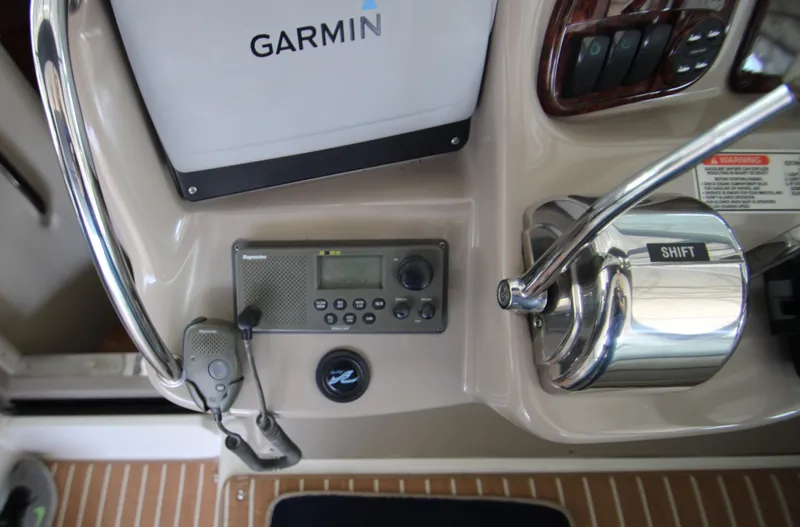 Slide: The Image of Control panel of 2003 Sea Ray 320 Sundancer with Garmin navigation and Raymarine radio. - 37