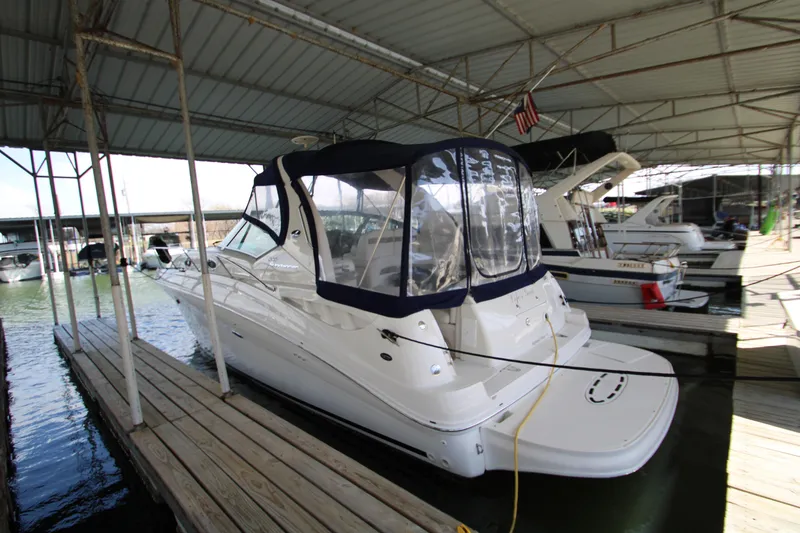 Slide: The Image of 2003 Sea Ray 320 Sundancer docked under covered marina. - 4