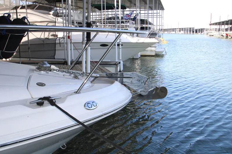 Slide: The Image of 2003 Sea Ray 320 Sundancer docked at marina, showcasing anchor and bow details. - 43