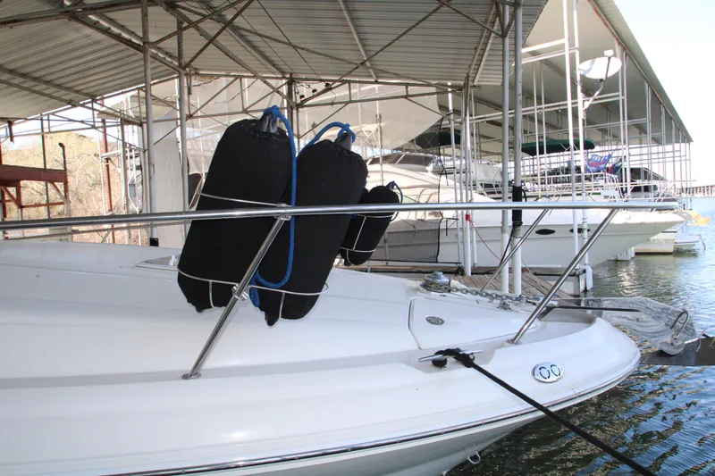 Slide: The Image of 2003 Sea Ray 320 Sundancer docked under a metal canopy. - 44