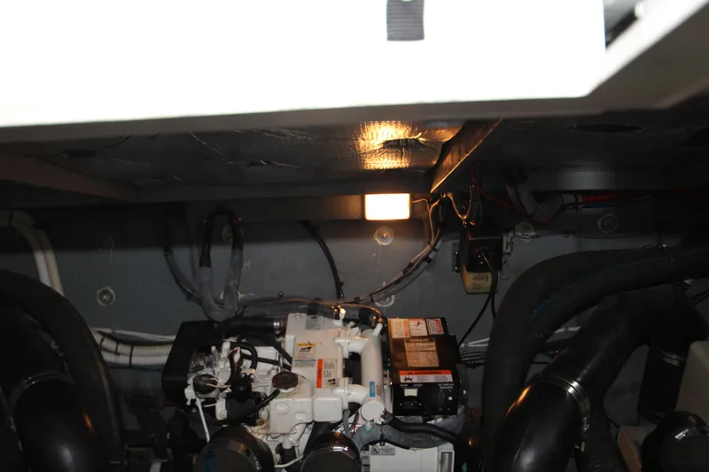 Slide: The Image of Engine room of 2003 Sea Ray 320 Sundancer with visible components and lighting. - 47