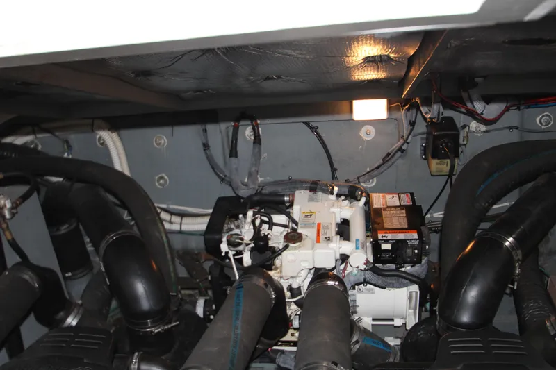 Slide: The Image of Engine room of 2003 Sea Ray 320 Sundancer with visible machinery and wiring. - 49