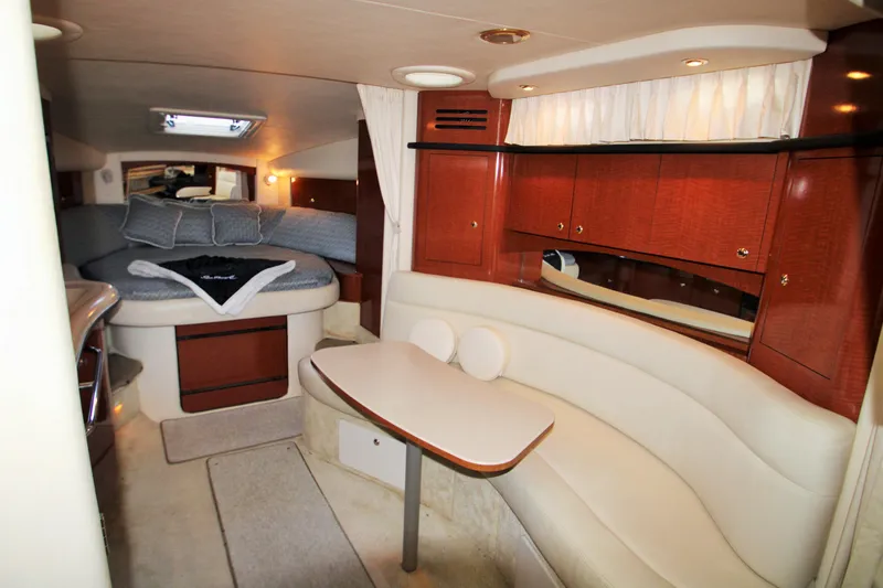 Slide: The Image of Interior of 2003 Sea Ray 320 Sundancer yacht with cozy seating and elegant wood cabinetry. - 6