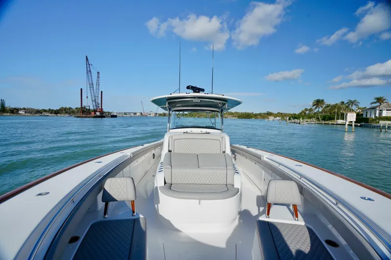 Slide: The Image of 2021 Valhalla Boatworks V46 on calm water, clear sky, and coastal backdrop. - 11