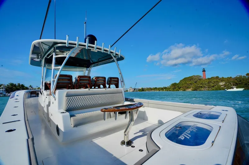 Slide: The Image of 2021 Valhalla Boatworks V46 on water, lighthouse in background, clear blue sky. - 12