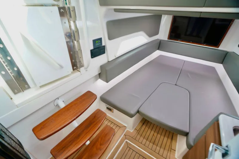 Slide: The Image of 2021 Valhalla Boatworks V46 interior cabin with modern seating and wooden steps. - 19