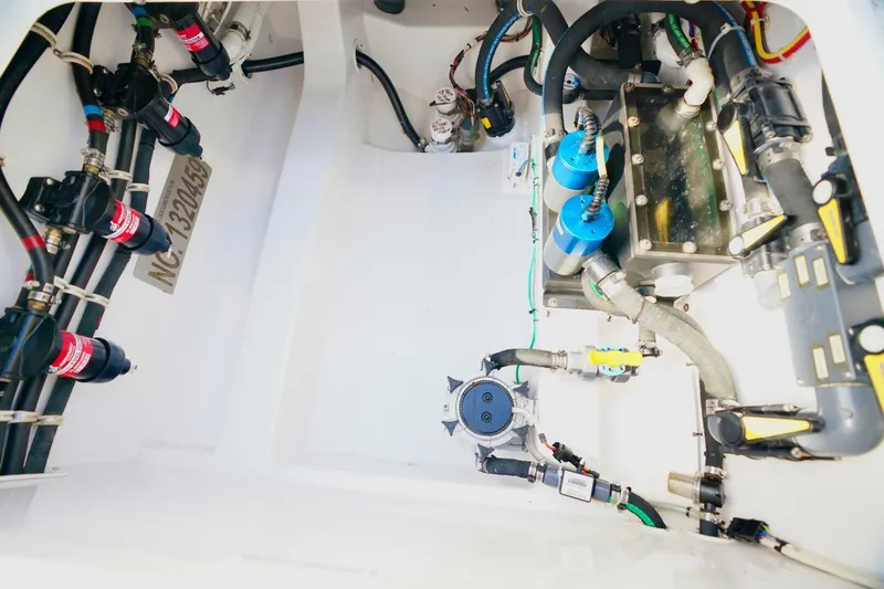 Slide: The Image of Engine compartment of 2021 Valhalla Boatworks V46, showcasing intricate wiring and components. - 23