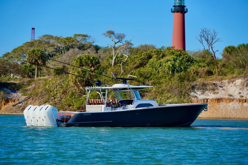 Slide: The Image of 2021 Valhalla Boatworks V46 cruising near a lighthouse, surrounded by lush greenery. - 3