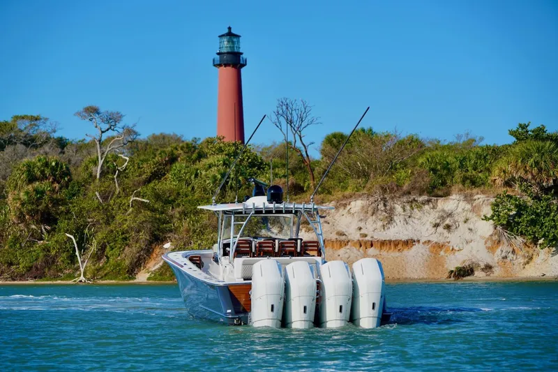 Slide: The Image of 2021 Valhalla Boatworks V46 cruising near a lighthouse with lush greenery. - 6