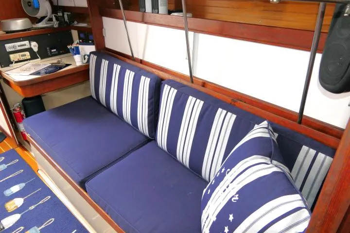Slide: The Image of Interior of 1988 Catalina 34 sailboat with blue striped cushions and nautical decor. - 13