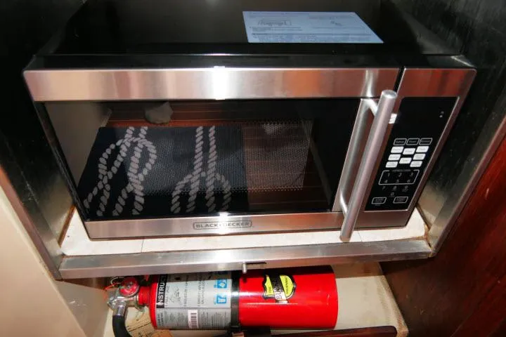 Slide: The Image of Microwave and fire extinguisher in 1988 Catalina 34 yacht kitchen setup. - 21