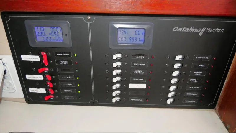 Slide: The Image of Electrical control panel of a 1988 Catalina 34 yacht with switches and digital displays. - 27